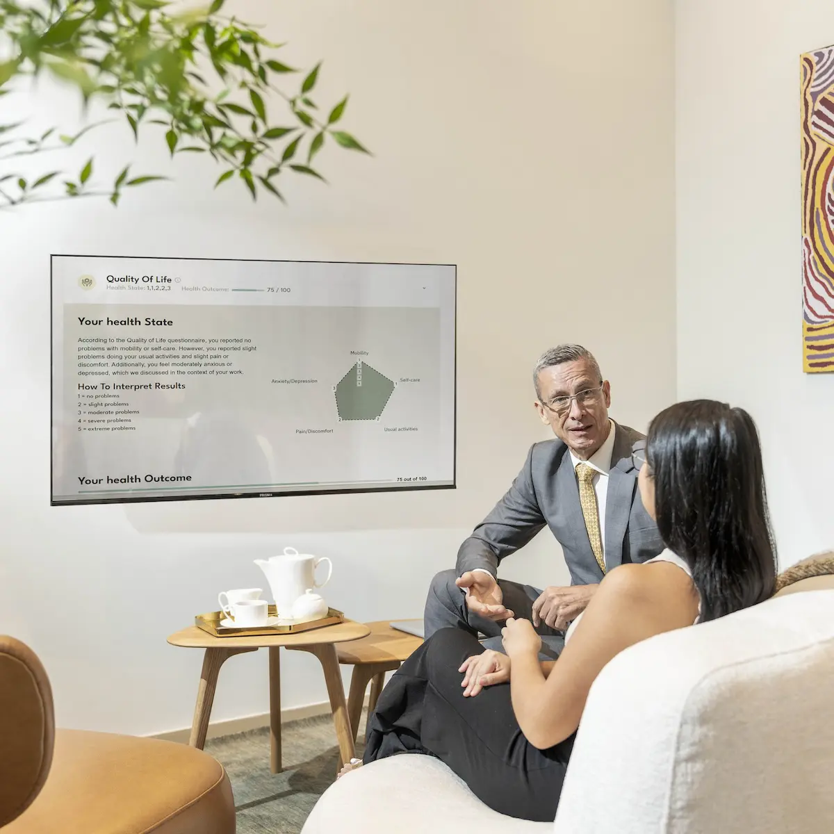 A Chi Longevity expert reviewing a client's quality-of-life results on screen during a consultation.